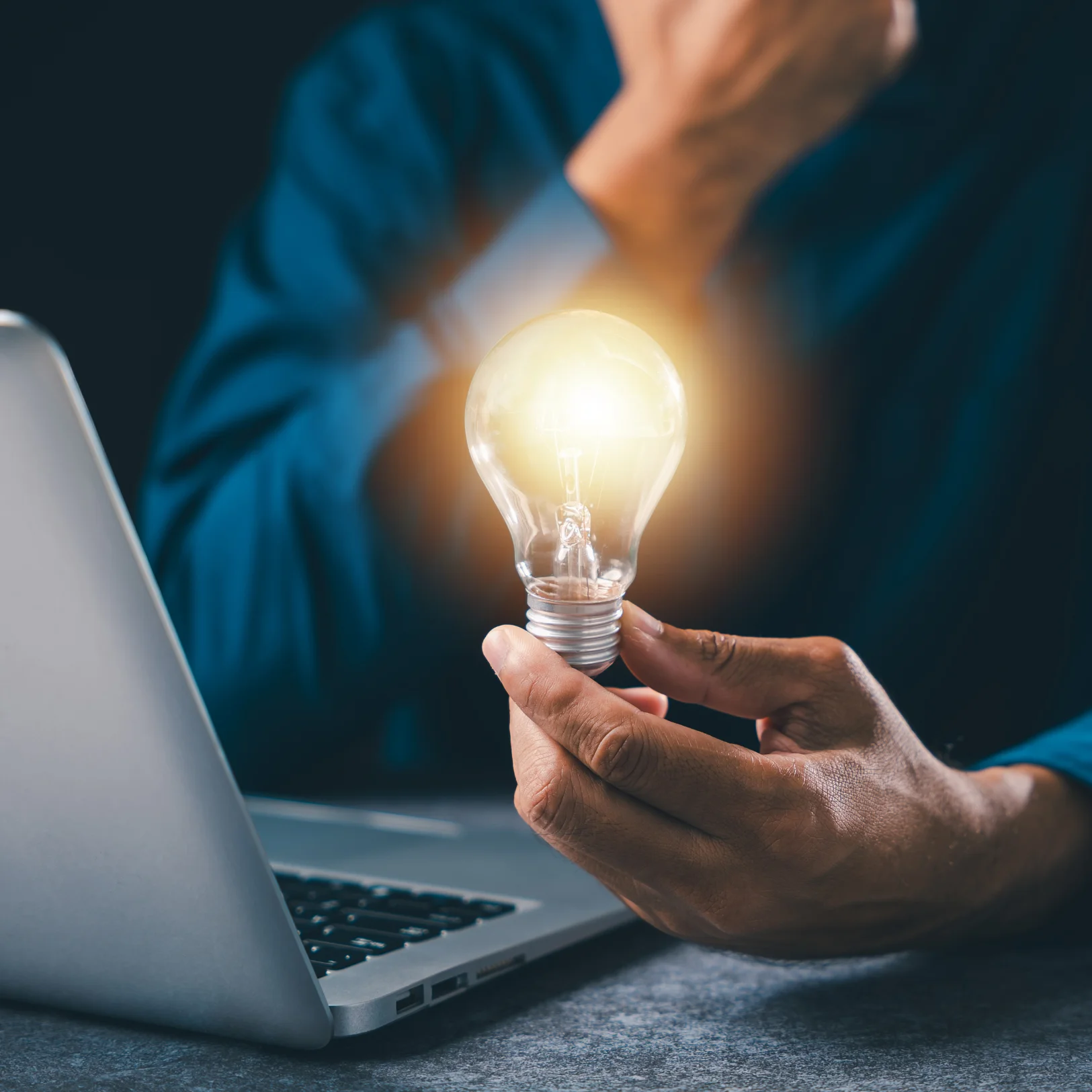IT specialist holding a glowing lightbulb representing innovative Managed IT Services for Houston businesses